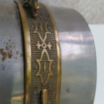 Ornate cast brass frame of the "Tin Can " movement housing. The Nickel plating and oxidation clearly visible. 
